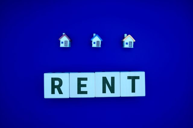 the word rent under small house figurines